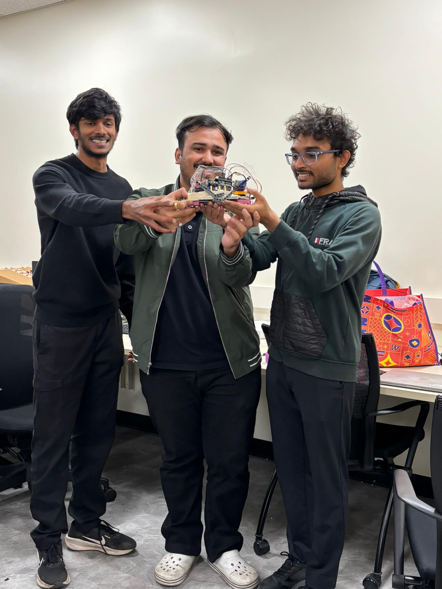 Team holding the finished quadruped
